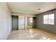 Simple bedroom with mirrored closet doors and tile flooring at 4880 Welter Ave, Las Vegas, NV 89104