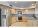 Kitchen with stainless steel appliances and light wood cabinets at 7844 Bluewater Dr, Las Vegas, NV 89128