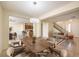 Bright dining room features a large wood table and access to the kitchen and living areas at 8320 S Pioneer Way, Las Vegas, NV 89113