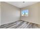 Bedroom with large window and wood-look floors at 9309 Deer Lodge Ln, Las Vegas, NV 89129