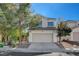 Two-story house with attached garage and landscaping at 9309 Deer Lodge Ln, Las Vegas, NV 89129