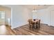 Bright dining room with hardwood floors and a wood table, offering plenty of space for entertaining at 4725 Basilicata Ln # 204, North Las Vegas, NV 89084