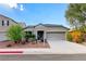 Single-story house with gray exterior, two-car garage, and landscaped front yard at 1153 Pine Cove Ct, Henderson, NV 89011