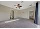 Bright bedroom with carpet flooring and doors to hallway and bathroom at 2 Vicolo Verdi, Henderson, NV 89011