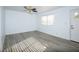 Simple bedroom featuring gray vinyl flooring and a window at 2060 Bowman Rd, Logandale, NV 89021