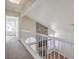 Upstairs hallway overlooking living room with stone fireplace at 2813 Prickley Pear Dr, Henderson, NV 89074