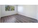 Spacious bedroom with grey wood-look flooring and large window at 6121 Fairwood Cir, Las Vegas, NV 89107