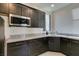 Dark wood cabinets and granite countertops in kitchen at 8637 Home Gate Ct, Las Vegas, NV 89113