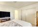 Bedroom with a queen bed, TV, and built-in wardrobe at 8745 Smokey Dr, Las Vegas, NV 89134