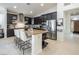 Modern kitchen with dark cabinetry, granite island, and stainless steel appliances at 9843 High Alpine St, Las Vegas, NV 89178