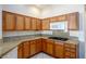 Spacious kitchen with oak cabinets and granite countertops at 10628 Mission Lakes Ave, Las Vegas, NV 89134