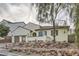 House exterior with a stone retaining wall and mature trees at 1189 Hillside Peak St, Henderson, NV 89002