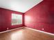 Bedroom with red walls, hardwood floors, and a window at 216 Red Cloud Ter, Henderson, NV 89015