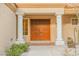 Inviting front entrance with double doors, columns, and landscaping at 3105 Birdwood Dr, Las Vegas, NV 89134