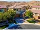 Two-story house with brown garage door, landscaping, and brick accents at 3409 Iron Hagen Ct, Las Vegas, NV 89141