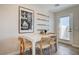 Bright dining area with white table and four chairs near sliding door at 344 Banished Ave # 3, North Las Vegas, NV 89031