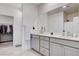 Double vanity bathroom with a large mirror and plenty of cabinet storage at 3524 Crotone Ave, Henderson, NV 89044