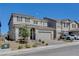 Two-story house with gray exterior, a three-car garage, and landscaping at 3524 Crotone Ave, Henderson, NV 89044