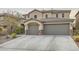 Two-story home with a three-car garage, stone accents, and a landscaped front yard at 3605 Sapphire Sea Ct, North Las Vegas, NV 89031