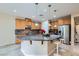 Kitchen island with granite countertop, white barstools, and stainless steel appliances at 3605 Sapphire Sea Ct, North Las Vegas, NV 89031