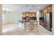 Kitchen with an island with seating, wood cabinets, and a dining area at 3605 Sapphire Sea Ct, North Las Vegas, NV 89031