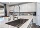 Modern kitchen sink and faucet with quartz countertop at 4008 W Le Baron Ave, Las Vegas, NV 89141