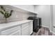 Laundry room with white cabinets, quartz countertops and new washer/dryer at 4008 W Le Baron Ave, Las Vegas, NV 89141