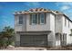 Two-story house with gray siding, gray garage door, and dark shutters at 4202 Yucca Brevi Ave, Las Vegas, NV 89139