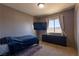 Bedroom with a double bed, large window, and a wall-mounted TV at 436 Emden St, Henderson, NV 89015