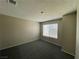 Simple bedroom with gray carpet and window blinds at 6409 Morley Ave, Las Vegas, NV 89108