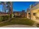 Landscaped backyard with a grassy area and palm trees at 8109 Dark Hollow Pl, Las Vegas, NV 89117