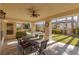 Covered patio with seating area, overlooking the pool and yard at 8109 Dark Hollow Pl, Las Vegas, NV 89117