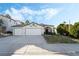 Two-story house with a three-car garage and landscaped front yard at 923 Highland Trails Ave, Henderson, NV 89015