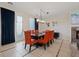 Elegant dining room with dark wood table and orange chairs at 11356 Belmont Lake Dr # 103, Las Vegas, NV 89135