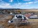 Aerial view showcasing a home with solar panels and a mountain backdrop at 1261 S Comstock St, Pahrump, NV 89048