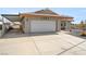 Single story home with a white garage door and gravel landscaping at 1261 S Comstock St, Pahrump, NV 89048