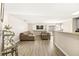 Living area with sectional sofa, hardwood floors, and built-in entertainment center at 2135 Prevail Dr, North Las Vegas, NV 89032