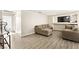 Living room with L-shaped sofa and hardwood floors, view of hallway at 2135 Prevail Dr, North Las Vegas, NV 89032