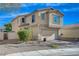 Two-story house with a two-car garage and nicely landscaped front yard at 3232 Pasolini Ct, North Las Vegas, NV 89032