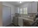 Bright laundry room with washer, dryer, and ample storage at 3850 Pacific St, Las Vegas, NV 89121