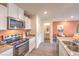 Modern kitchen with stainless steel appliances and a view of the half-bath at 4842 Currant Ridge Ave # 69, Las Vegas, NV 89141