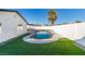 Inviting kidney-shaped pool with artificial turf and a covered patio at 5610 Surrey St, Las Vegas, NV 89119