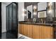 Elegant bathroom with double vanity, dark tile, and built-in storage at 7 Penn Cross Ct, Henderson, NV 89052