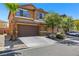 Two-story house with brown garage door and landscaping at 765 Crest Valley Pl, Henderson, NV 89011