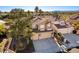 Aerial view of two story home with three car garage and desert landscape at 8229 Sedona Sunrise Dr, Las Vegas, NV 89128