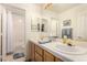 Elegant bathroom with double sinks, tile flooring, and bathtub at 8229 Sedona Sunrise Dr, Las Vegas, NV 89128