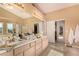 Large bathroom with dual sinks, soaking tub, and separate shower at 8229 Sedona Sunrise Dr, Las Vegas, NV 89128