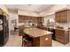 Kitchen with large island, granite counters, and ample cabinetry at 8229 Sedona Sunrise Dr, Las Vegas, NV 89128