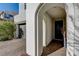 Covered entryway with arched opening and a black front door at 9660 Hiking Ave, Las Vegas, NV 89166