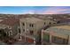 Dusk view of three-story home with attached two-car garage at 9872 Russian Hill St, Las Vegas, NV 89141